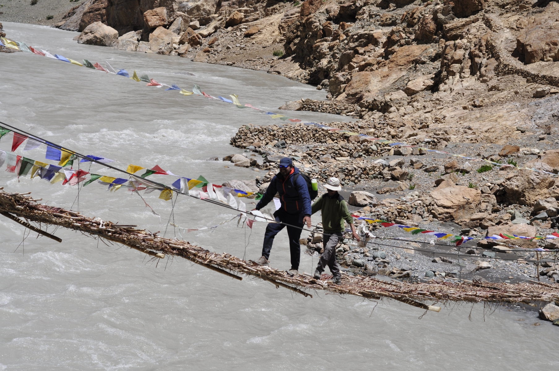 The Global Himalayan Expedition team crossing the bridge at 12000 ft over river Zanskar in Ladakh. On their way to electrify the 2500 year old Phugtal Monastry. Image credit: Global Himalayan Expedition.