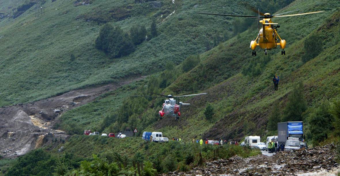 The A85 in Glen Ogle blocked by two debris flows on 18 August 2004. RAF and Royal Navy helicopters are pictured airlifting some of the 57 occupants from the 20 trapped vehicles to safety. Source: Live Land