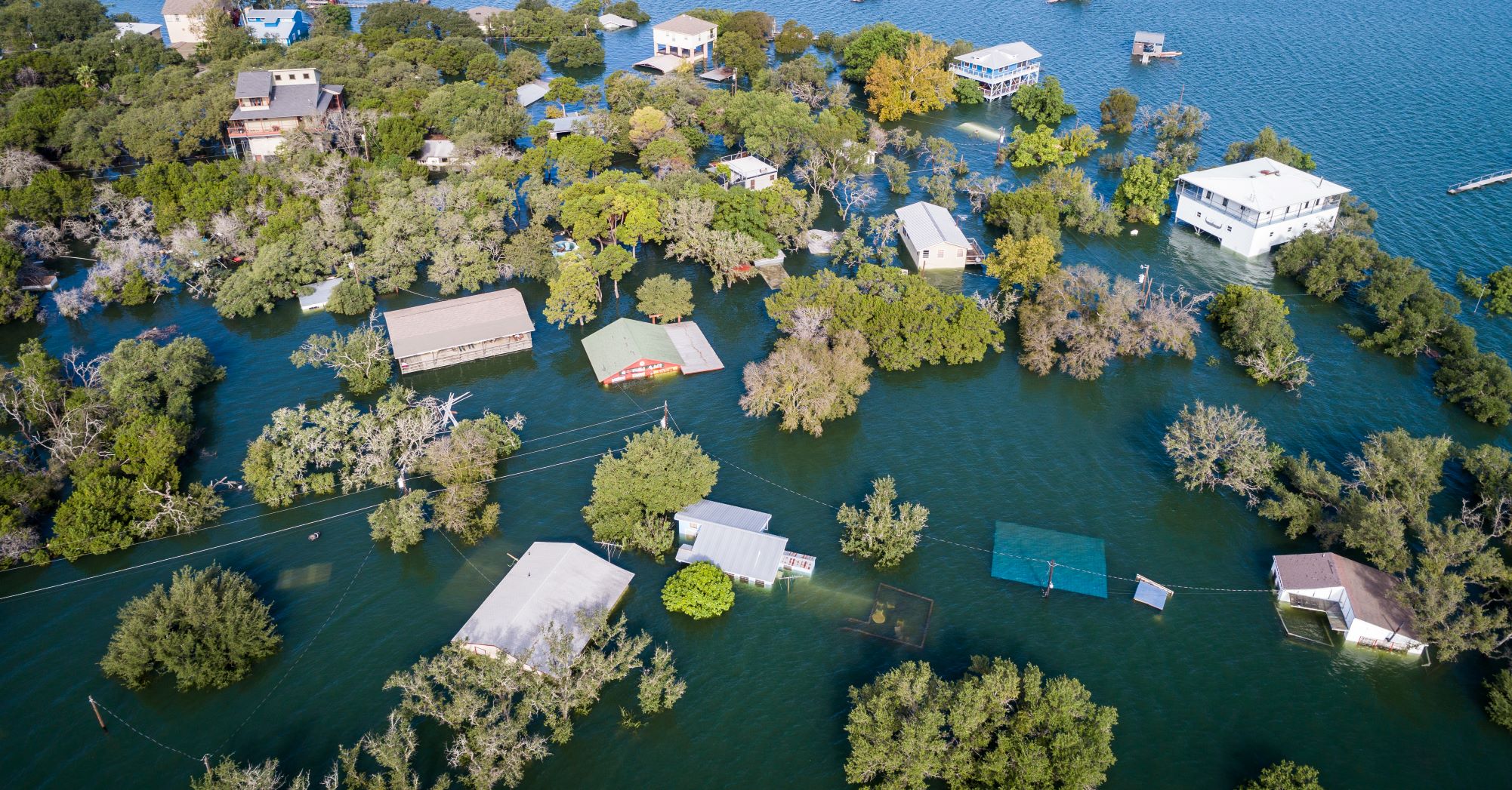  Multiple houses half under water as shown by aerial drone views high above flooding. Credit: Shutterstock/Roschetzky Photography