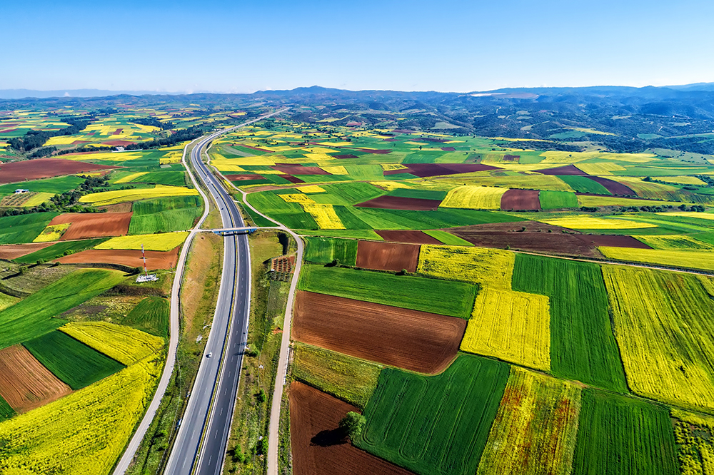 Aerial view of road passing through a rural landscape with blooming in northern Greece. Credit: Ververidis Vasilis, Shutterstock